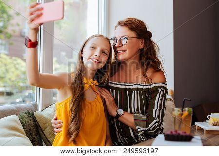 Teenage Girl. Modern Beautiful Teenage Girl Making Selfie With Her Loving Caring Mother Wearing Styl