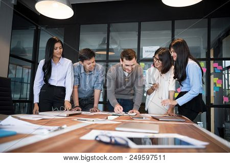 Group Of Young Modern People In Casual Wear Planning Business Strategy. Business Team Analyzing Inco