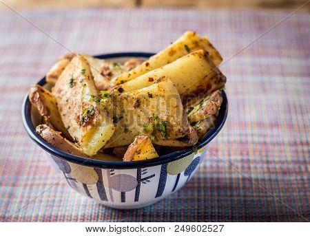 Delicious Panfried Chunky Chips Or Fries Garnished With Parsley Served In A Pretty Bowl In A Rustic 