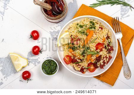 Savory Autumn Or Winter Bulgur Salad With Vegetables And Pesto Sauce On Wooden Table
