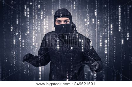 Burglar in action with encoded concept and his tools in his hand. 