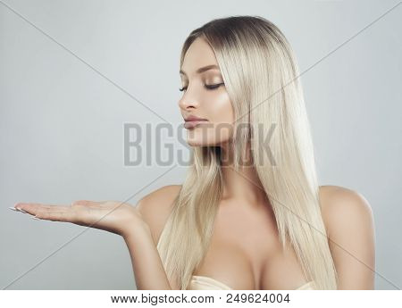 Cute Blonde Woman Spa Model With Healthy Skin, Long Hair And Natural Make Up Showing Empty Copy Spac