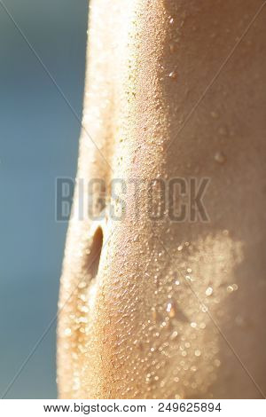 Wet Slim Woman Stomach After Workout On Blue Background