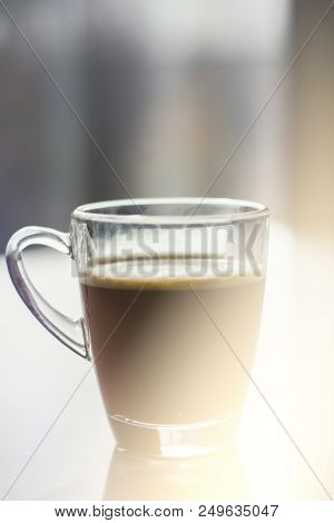 Black Espresso Coffee With Heady Froth In A Glass Mug Or Cup