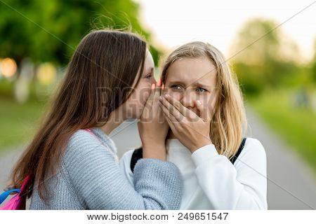Two Girl Friends Schoolgirls, Students. In Summer City. Tells A Friend Ear, Secret, Really. The Conc