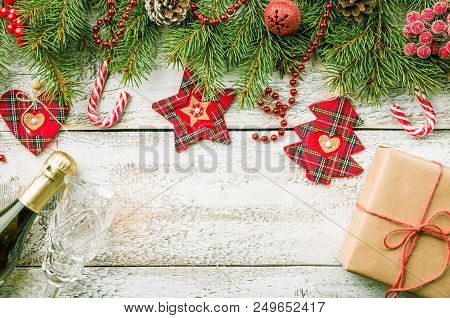 Christmas Composition With Fir Tree Branches And Red Christmas Decorations On White Wooden Backgroun