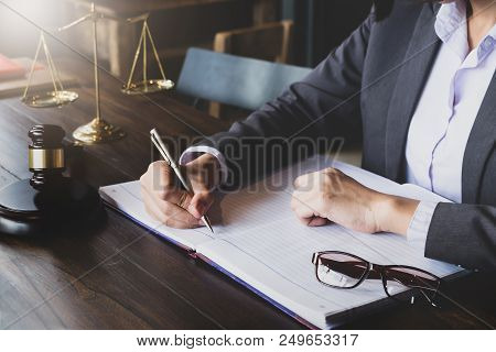 Advice And Justice Concept. Justice Scales And Justice Hammer And Female Lawyer Use Pen, Working Leg