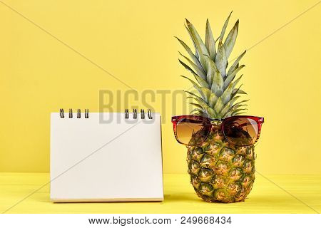 Ananas And Empty Binder Notepad. Pineapple With Sunglasses And Blank Paper Notebok On Color Backgrou