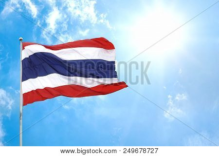 Thai National Flag Of Thailand Waving Blown And Ripple Away By Wind With Beautiful Blue Sky,clouds A