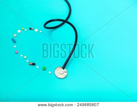 Medicine Stethoscope And Pills On Blue Background. Cardiology Heart Treatment.