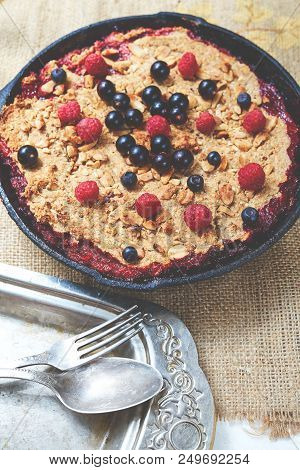 Summer Breakfast. Crumble With Blueberries In The Black Cast-iron Frying Pan On The White Table. Top