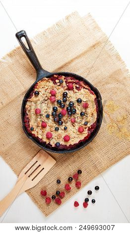 Summer Breakfast. Crumble With Blueberries In The Black Cast-iron Frying Pan On The White Table. Top