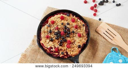Summer Breakfast. Crumble With Blueberries In The Black Cast-iron Frying Pan On The White Table. Top