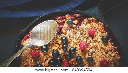 Summer Breakfast. Crumble With Blueberries In The Black Cast-iron Frying Pan On The Dark Stone Table