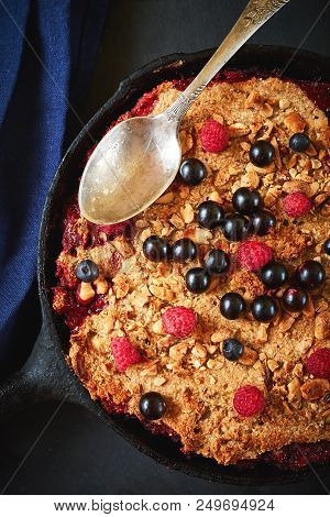 Summer Breakfast. Crumble With Blueberries In The Black Cast-iron Frying Pan On The Dark Stone Table