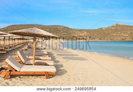 Straw Umbrellas And Sunbeds, Aquamarine Sea And Soft White Sand Of Beautiful Simos Beach, Elafonisos