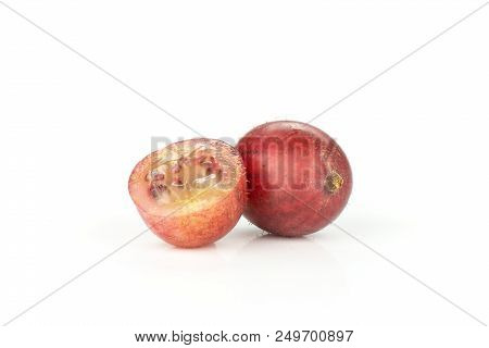 Group Of One Whole One Half Of Fresh Red Gooseberry Hinnomaki Variety Isolated On White