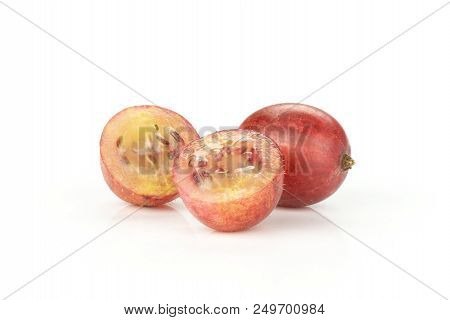 Group Of One Whole Two Halves Of Fresh Red Gooseberry Hinnomaki Variety Isolated On White