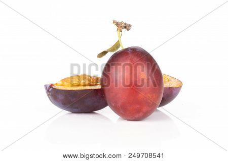 Group Of One Whole Two Halves Of Fresh Violet-blue Plum Vibrant Moyer Variety Isolated On White