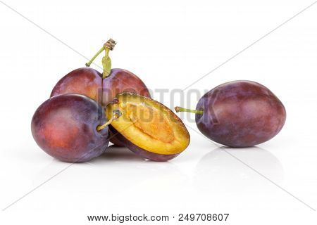 Group Of Three Whole One Half Of Fresh Violet-blue Plum Vibrant Moyer Variety Isolated On White