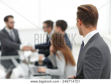 Business partners shaking hands over business objects on workpla