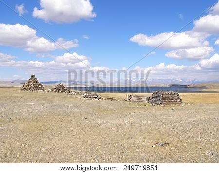 Mongolia Natural Landscapes, Surrounded By Mountains And Rocks And Bulls