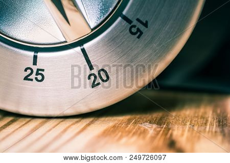 20 Minutes - A Macro Of An Analog Chrome Kitchen Timer On Wooden Table