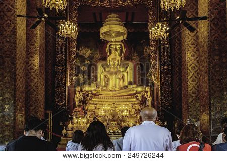 Thai People Prying To Buddha Figure In Thailand Public Temple. Believe In Religion Concept