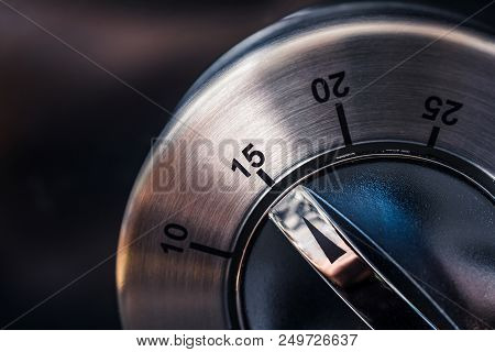 15 Minutes - A Macro Of An Analog Chrome Kitchen Timer With Dark Background