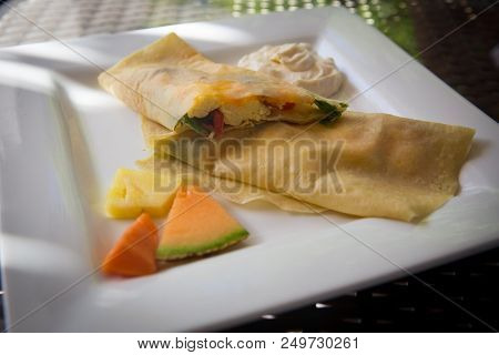Sliced Stuffed Breakfast Crepe With Eggs, Spinach And Cheese