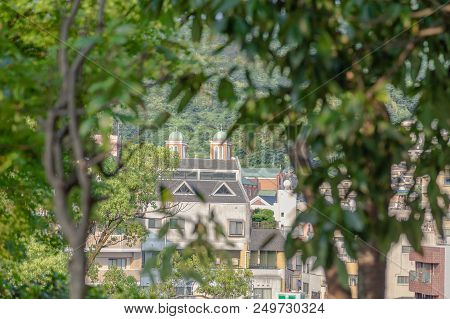 Nagasaki, Japan - 14jul2018:  Far Away View Through Vegitation Of Urakami Cathedral In Nagasaki, Jap