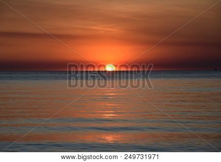 The Sun Casts Orange Shades Across An Evening Sky At Mindil Beach (darwin, Northern Territory, Austr