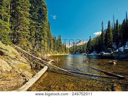 Lake Verna with rocks and mountains around at autumn. Rocky Mountain National Park in Colorado, USA. 