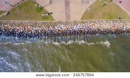 Aerial Top View Of Sea Waves Hitting Rocks On The Beach At Esplanade In Sipitang Town,sabah Borneo,m