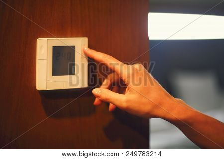 Hand Turning On Digital Climate Control. Close Up