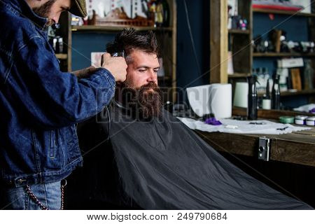 Hipster Lifestyle Concept. Hipster Client Getting Haircut. Barber With Hair Clipper Work On Hairstyl