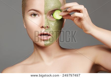 Beautiful Woman Applying Green Facial Mask. Beauty Treatments. Close-up Portrait Of Spa Girl Apply C