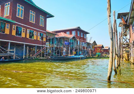 Inpawkhon, Myanmar - February 18, 2018: Canoe Boat With Water Delivers In Narrow Street Of The Villa