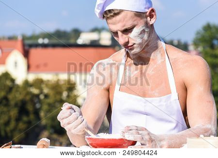 Baker Concept. Cook Or Chef With Sexy Muscular Shoulders And Chest Covered With Flour. Chef Cook Pre