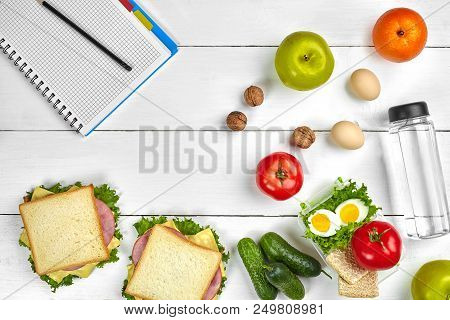 Top View Planning Notebook With Copy Space And Healthy Breakfast. Sandwich With Ham And Cheese, Eggs