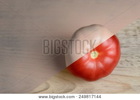 Natural Red And Beige Or Ecru Half Painted Tomato On Wooden Background