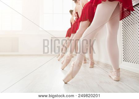 Ballet Background, Young Ballerinas Training. Female Dancers Legs In Pointe Shoes, Making Exercises.