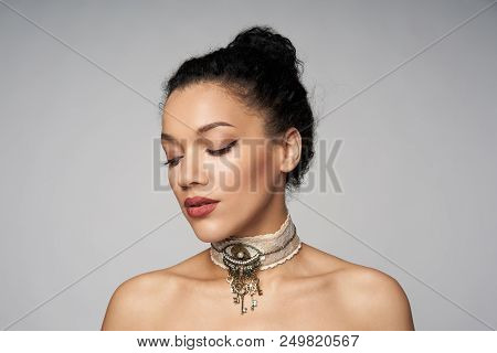 Beauty Closeup Portrait Of Beautiful Mixed Race Woman Wearing Chocker Posing, Isolated On Gray Backg