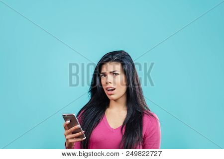 Unhappy Young Female After Reading Bad Information Fronm The Smartphone. Copy Space. Unpleasant Trut