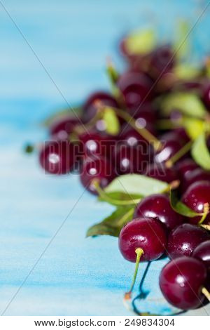 Ripe Fresh Cherries On A Blue Background, Close-up