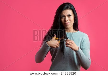 Angry Young Woman Is Going To Cut Hair. Cut Unhealthy Hair. Attractive Girl Is Getting Rid Of Brittl