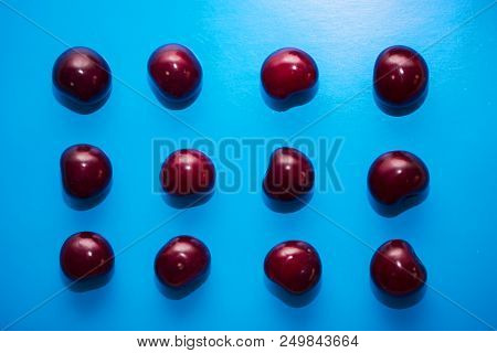 Collection Of Cherries Isolated On Blue Background.