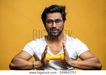 Pleasant Indian Sportsman Is Doing Exercies For Breast And Chest. Guy Is Trying To Break Dumbbell. C