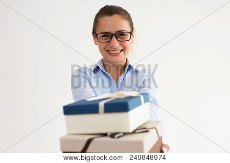 Positive Office Assistant Preparing Presents For Corporate Party. Smiling Caucasian Woman In Formal 