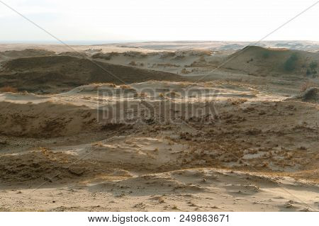 Sand Dune At Sunset, The Sea, The Hills Of Sand In The Sunlight
